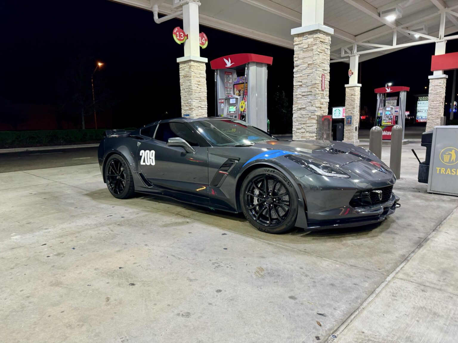 Corvette #209 at a gas station at night after a track day